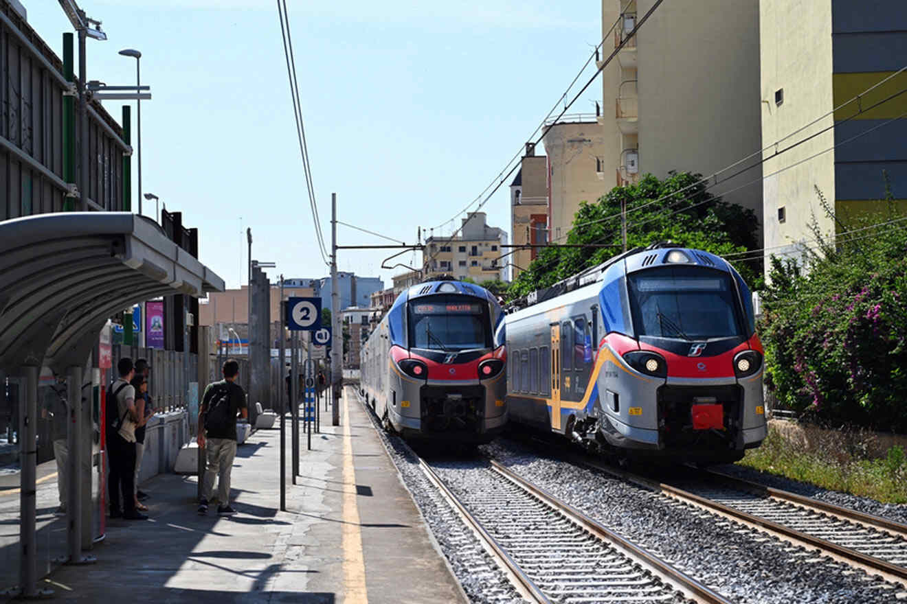 trains coming down the tracks at a train station.