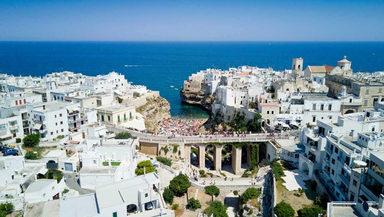 An aerial view of a white town near the ocean.