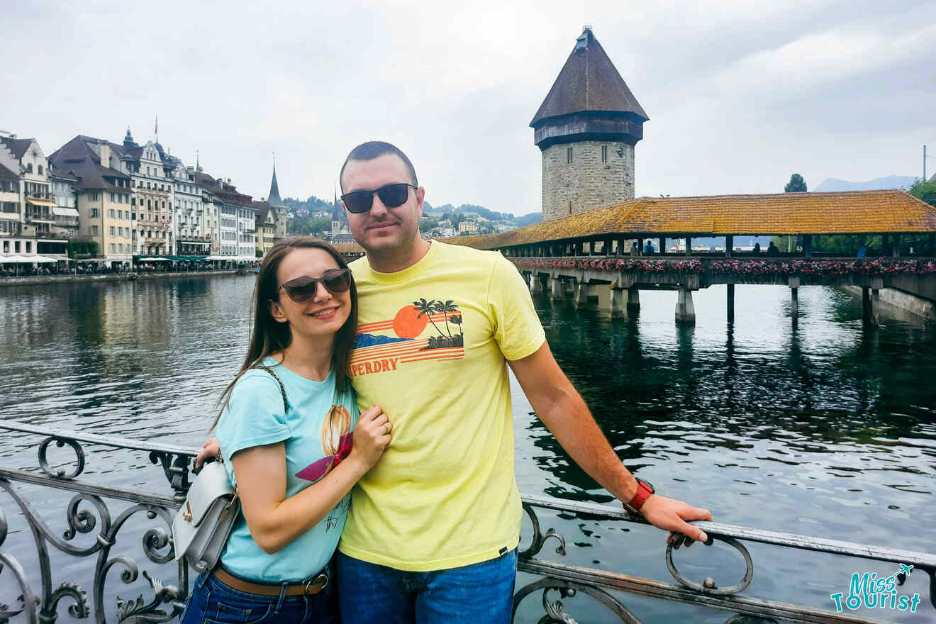 A couple posing in front of a bridge in switzerland.