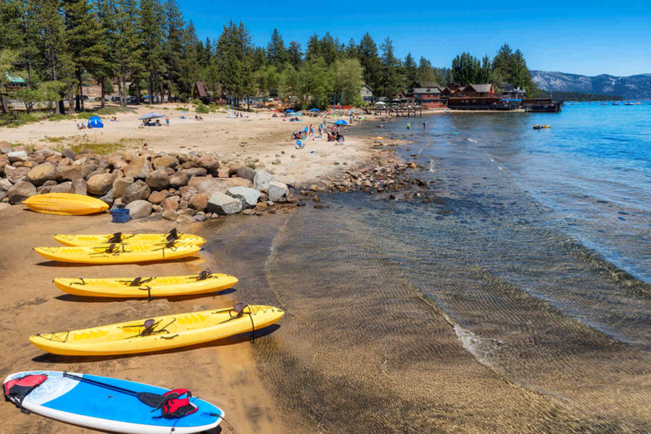Kayaks lined up on the shore of lake tahoe.