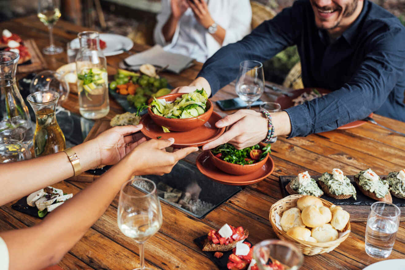 A group of people serving food at a restaurant.