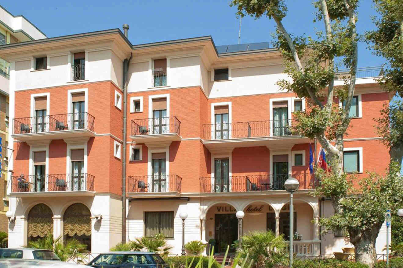 hotel's building with parked cars in front of it