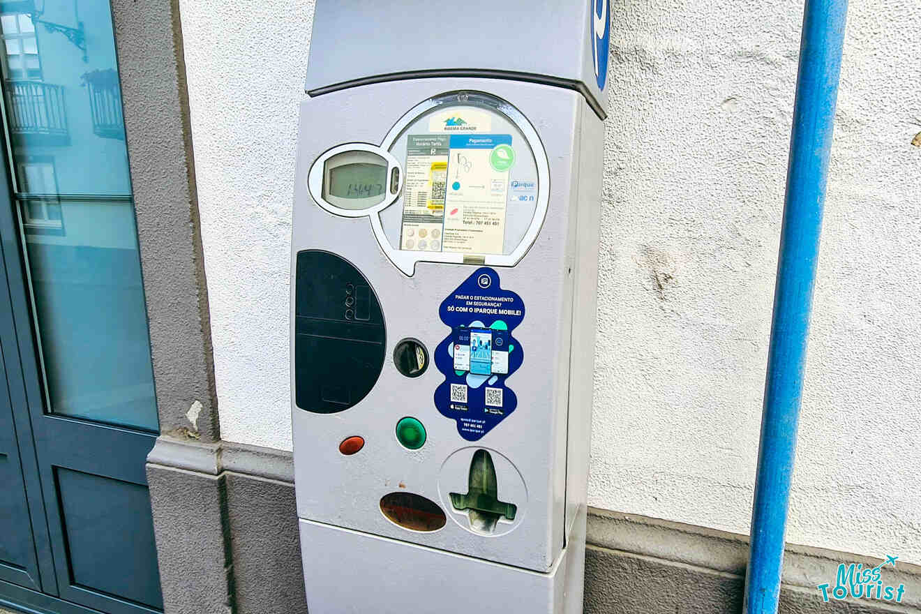 A parking meter on the side of a building.