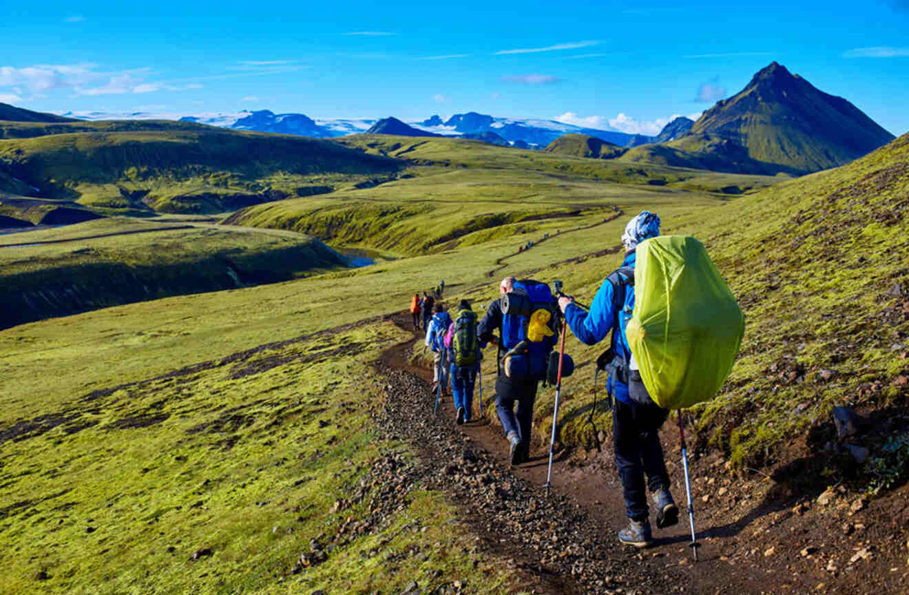 a line of people hiking on a mountain