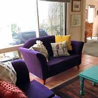 A purple couch in a living room.