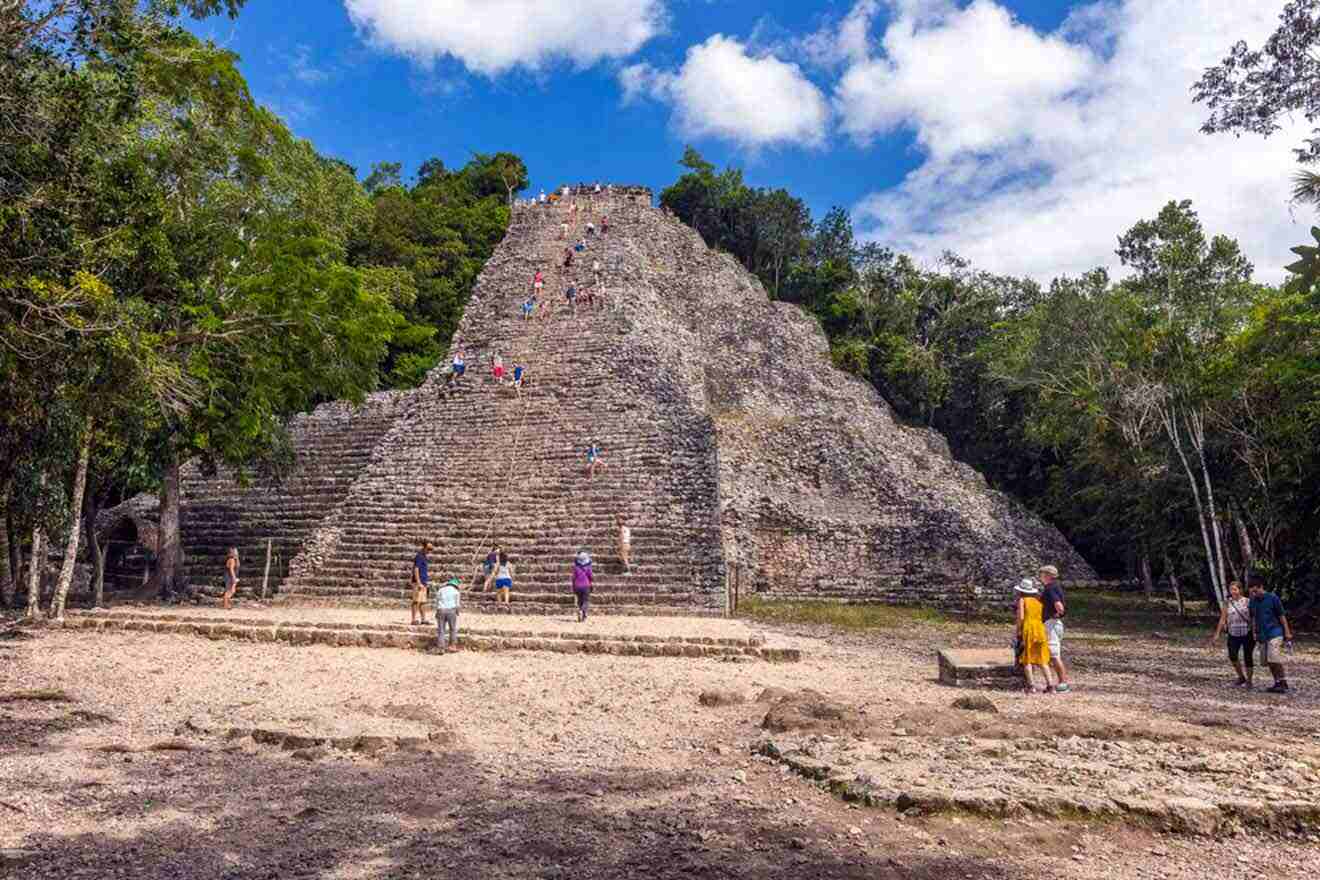 people walking around the mayan ruins at coba