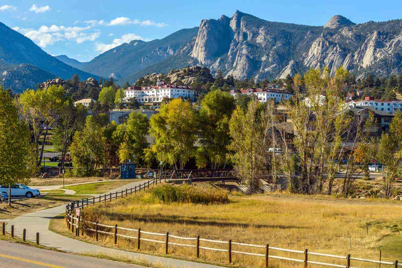 A view of a town in colorado with mountains in the background.