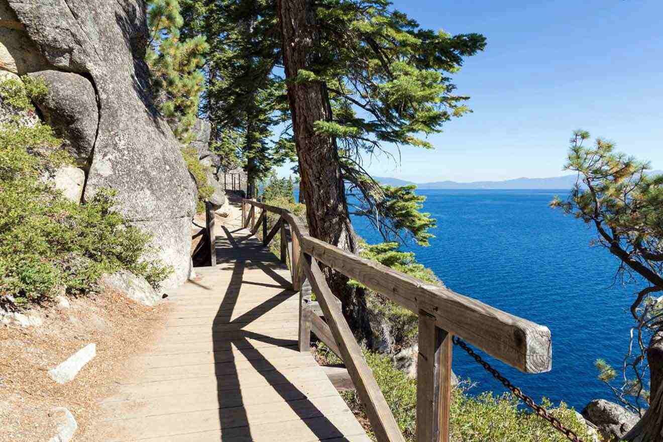 A wooden walkway leading to a cliff overlooking lake tahoe.