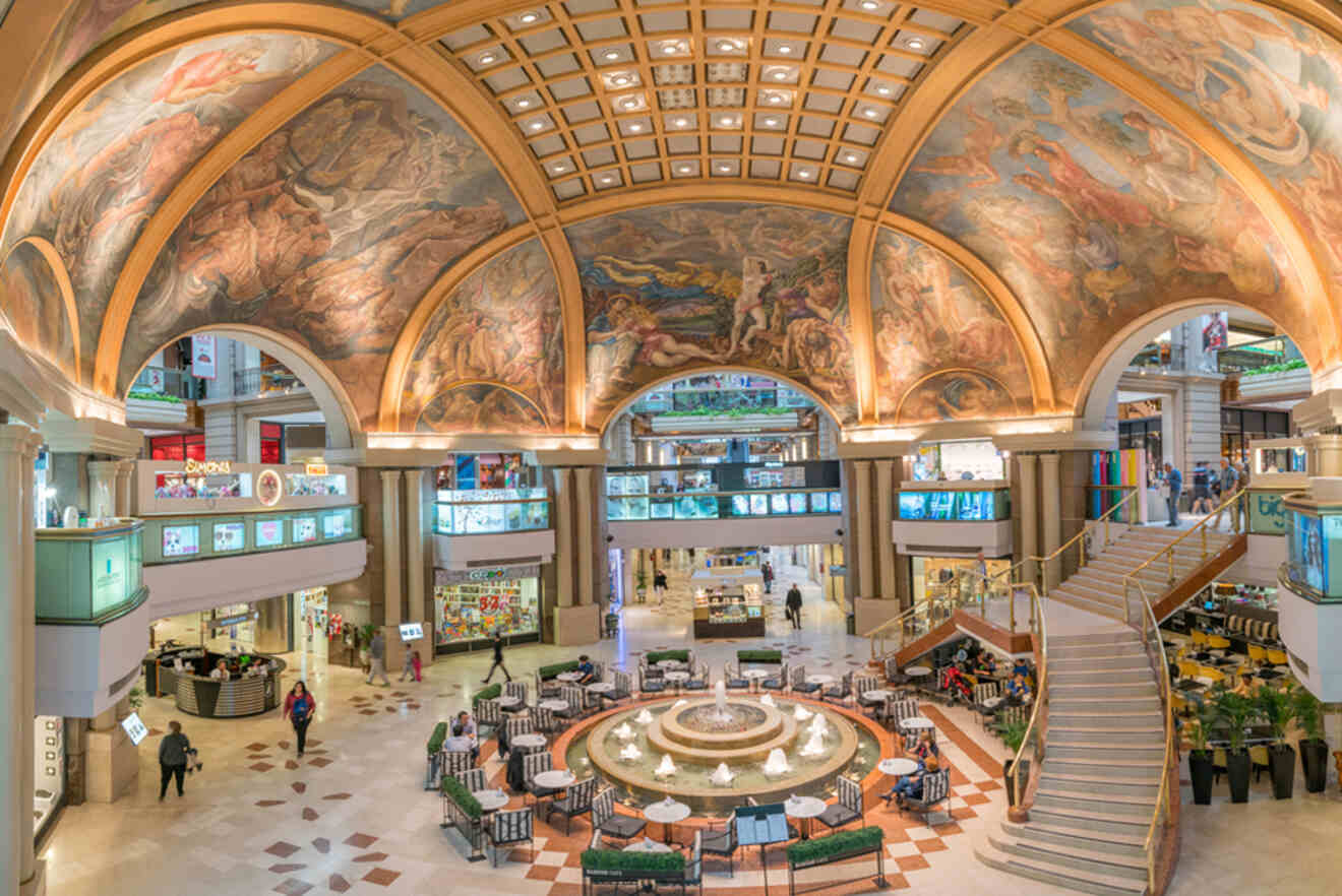 interior of a shopping mall with frescoes on the ceiling`