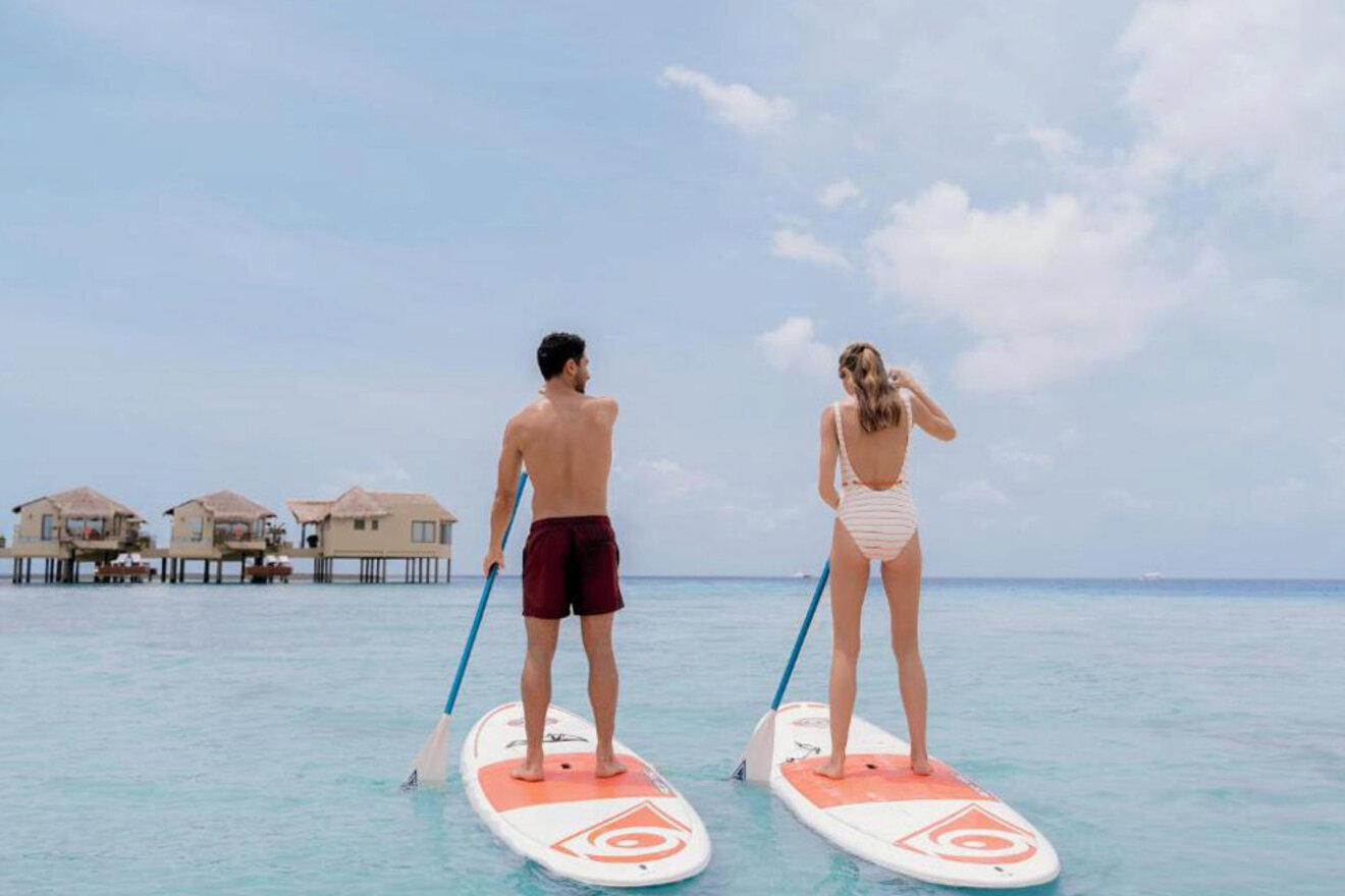 a man and a woman paddling on SUP boards