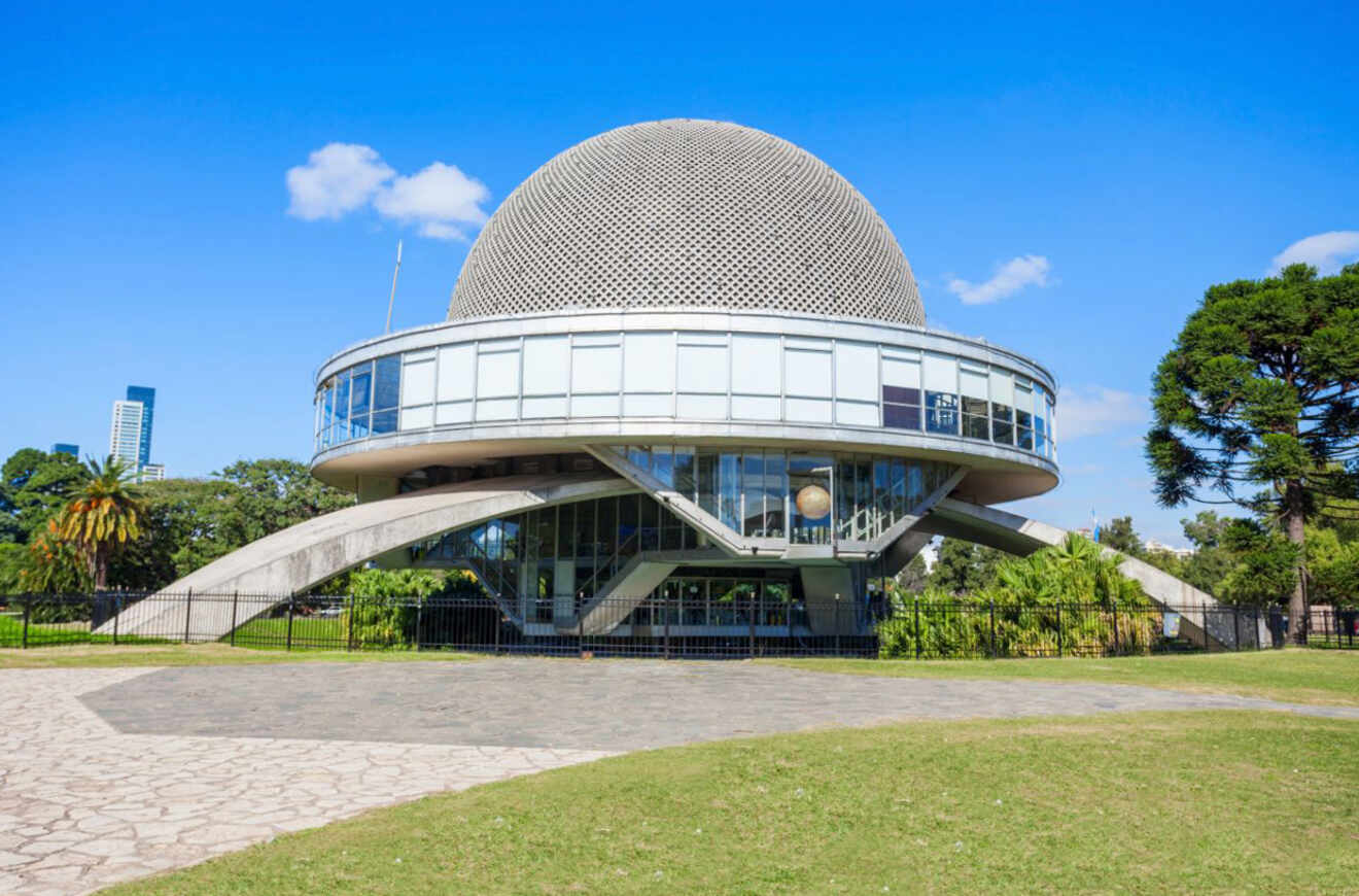 The distinctive architecture of the Galileo Galilei Planetarium in Buenos Aires, featuring its spherical dome, situated amidst the greenery of a park