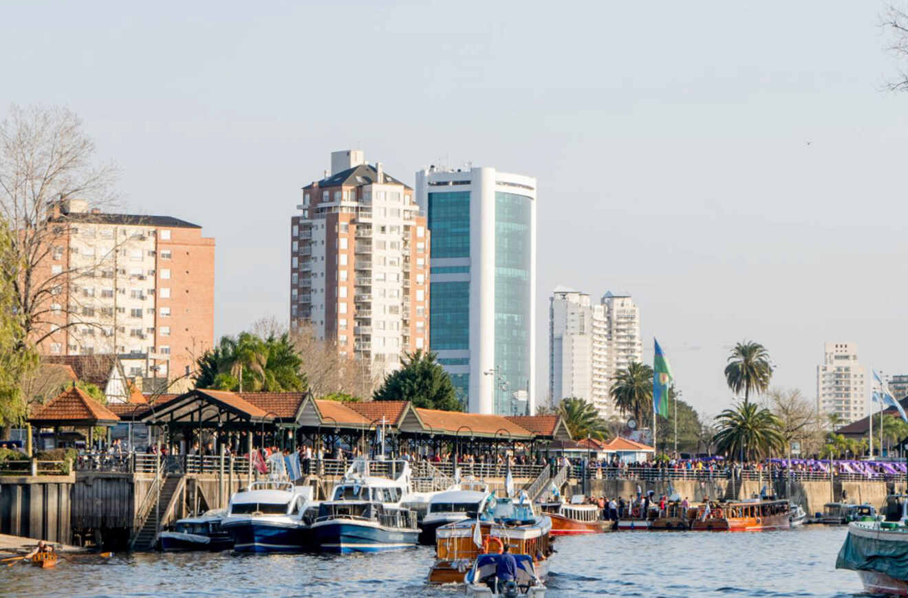 The waterfront of El Tigre, Buenos Aires, bustling with boats and docks, as locals and tourists enjoy the riverside ambiance among residential and commercial buildings
