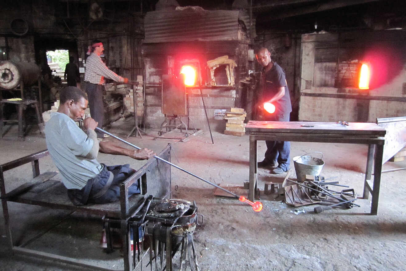 people working with and blowing glass
