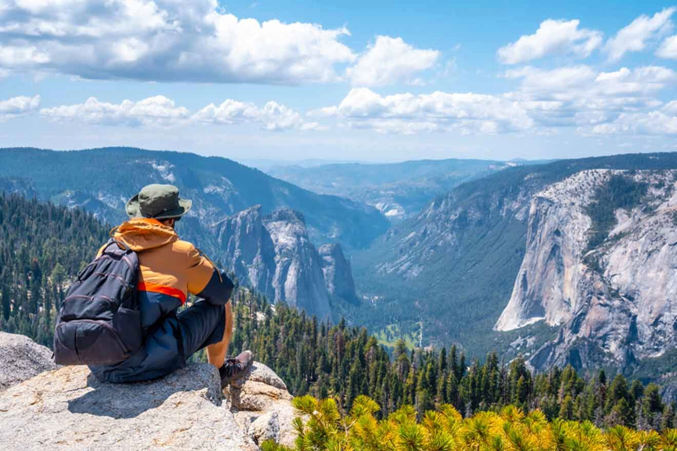 A man sitting on a rock overlooking yosemite national park.