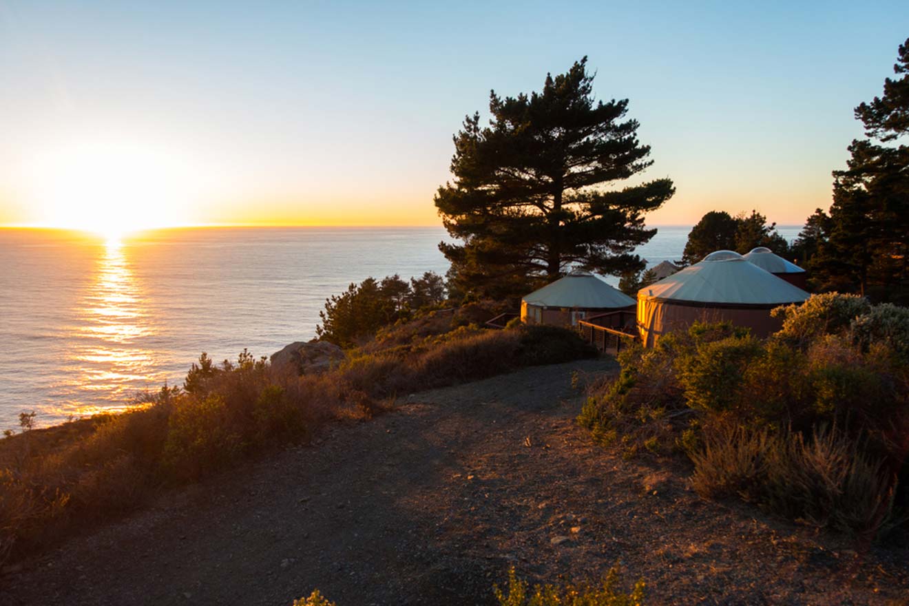A yurt sits on top of a hill overlooking the ocean.