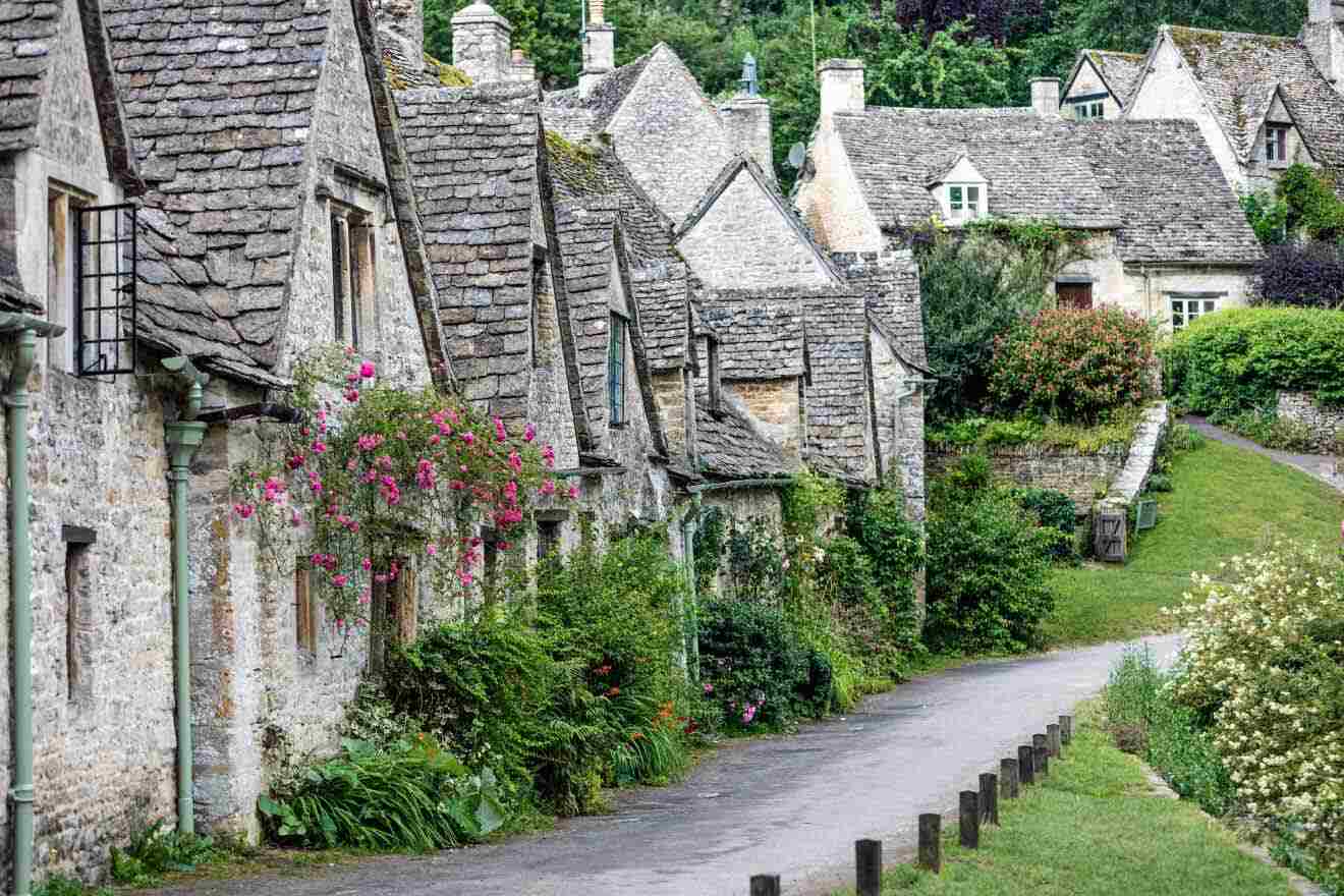 row of stone houses with lots of greenery and flowers