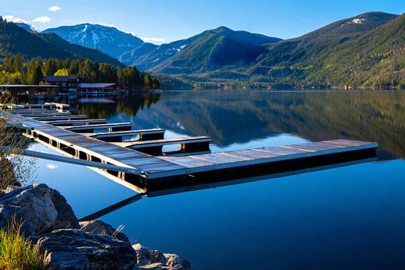 A dock on a lake with mountains in the background.