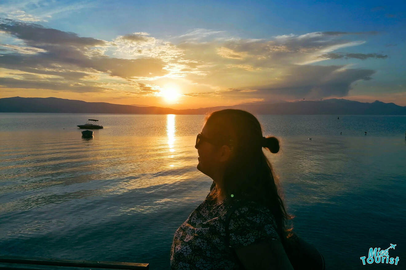 a girl posing by Ohrid lake at sunset
