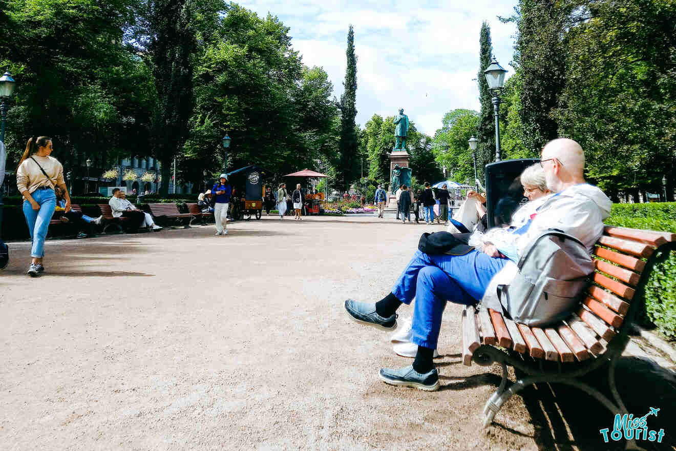 people sitting on a bench in a park