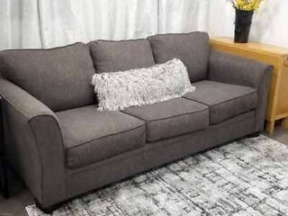 A gray couch in a living room.