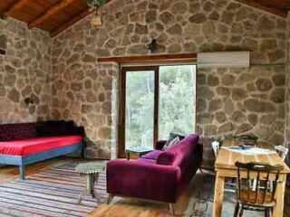 A room with a stone wall and a couch.
