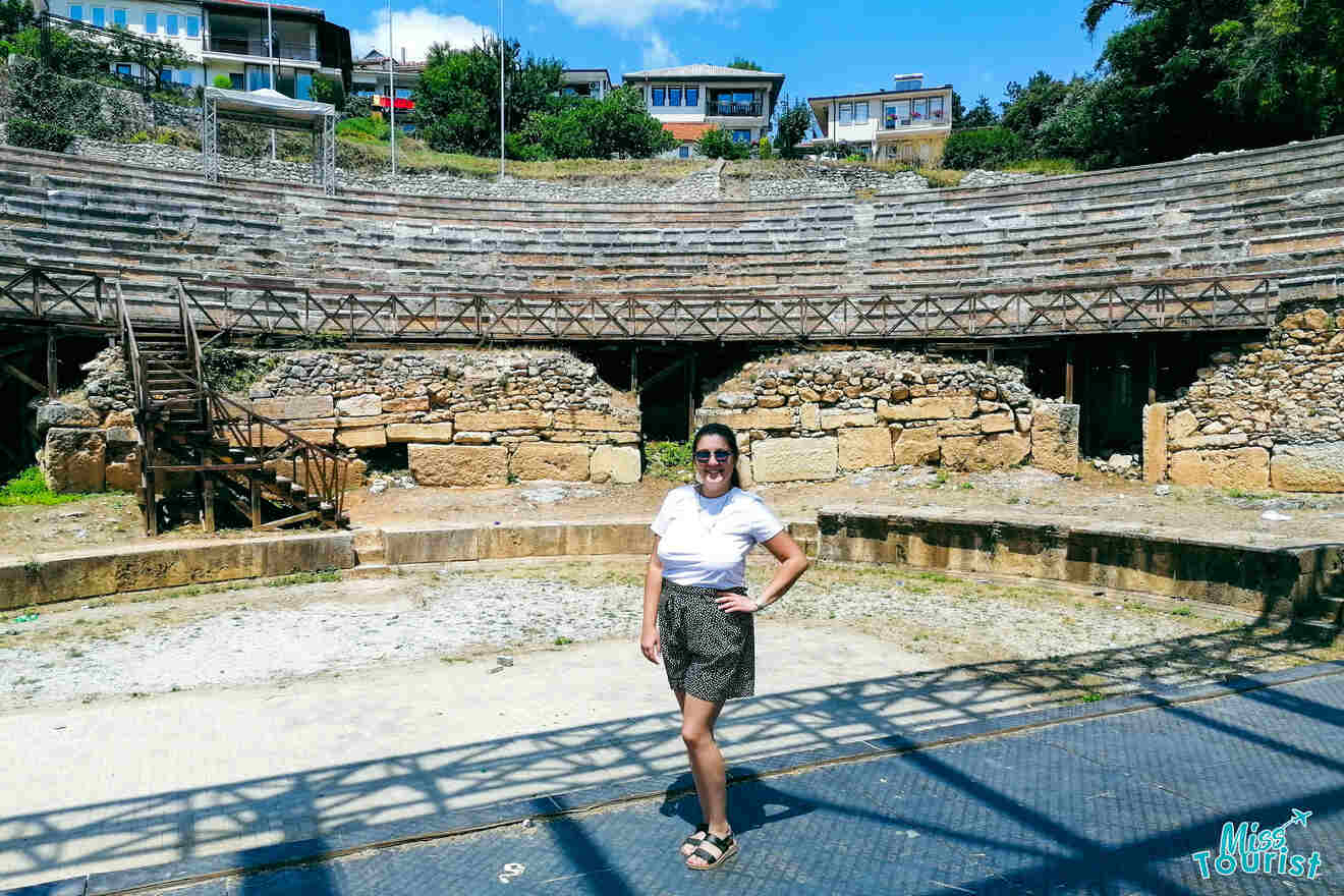 a girl posing at an ancient theatre