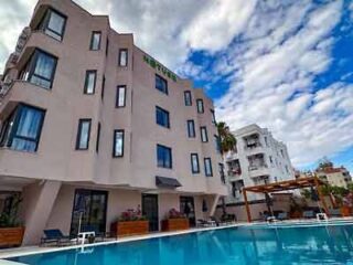 hotel's building with a pool in front of it