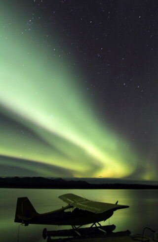 view of northern lights with a float plane in the foreground