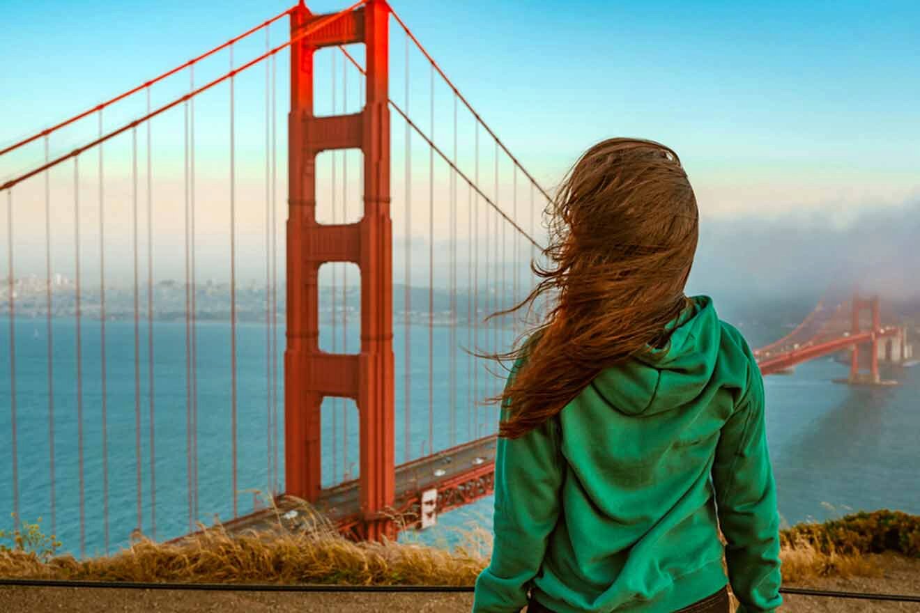 A woman looking at the golden gate bridge in san francisco.