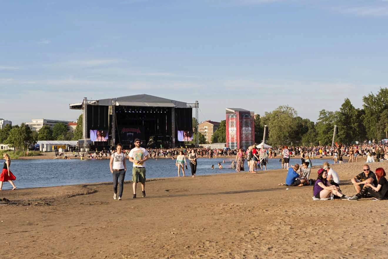 A group of people sitting on the beach at a concert