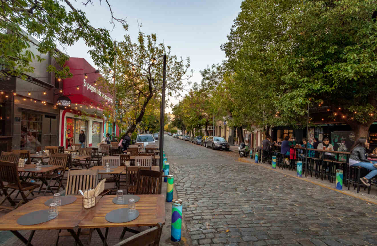 a cobbled street with cafes and restaurants