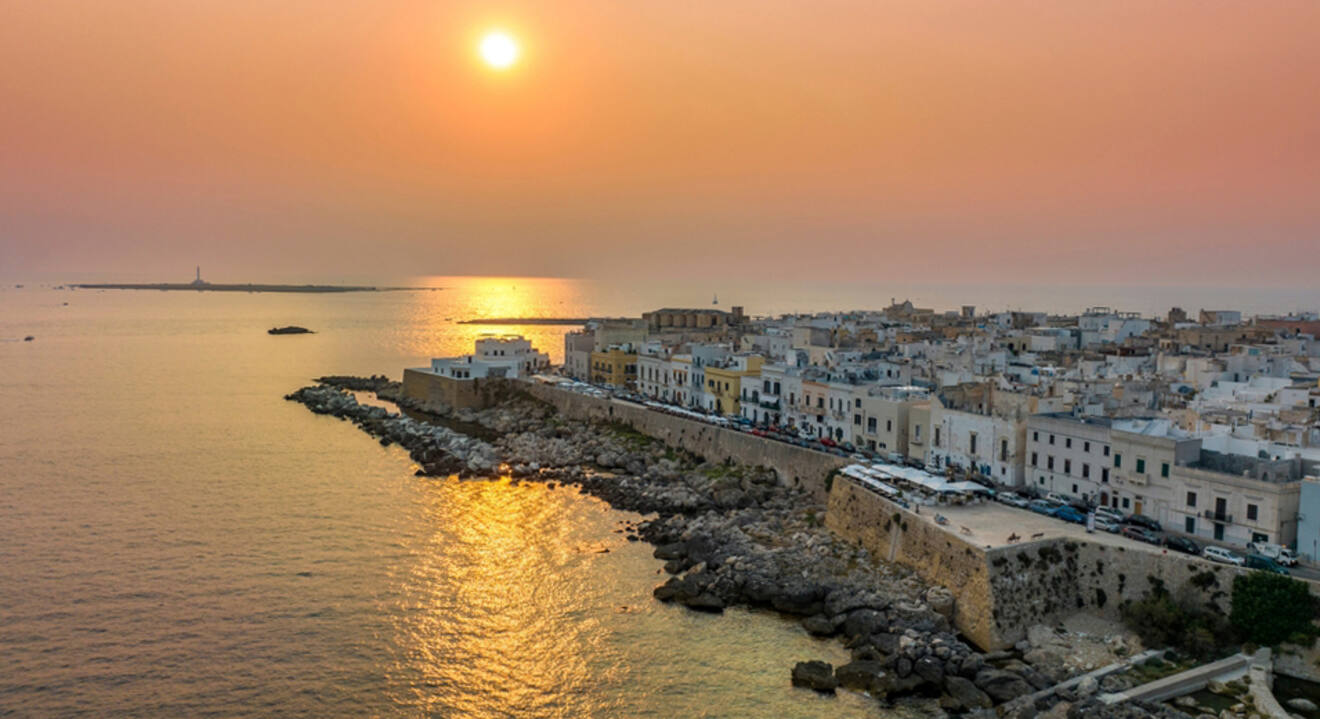 aerial view of a city on the coast at sunset