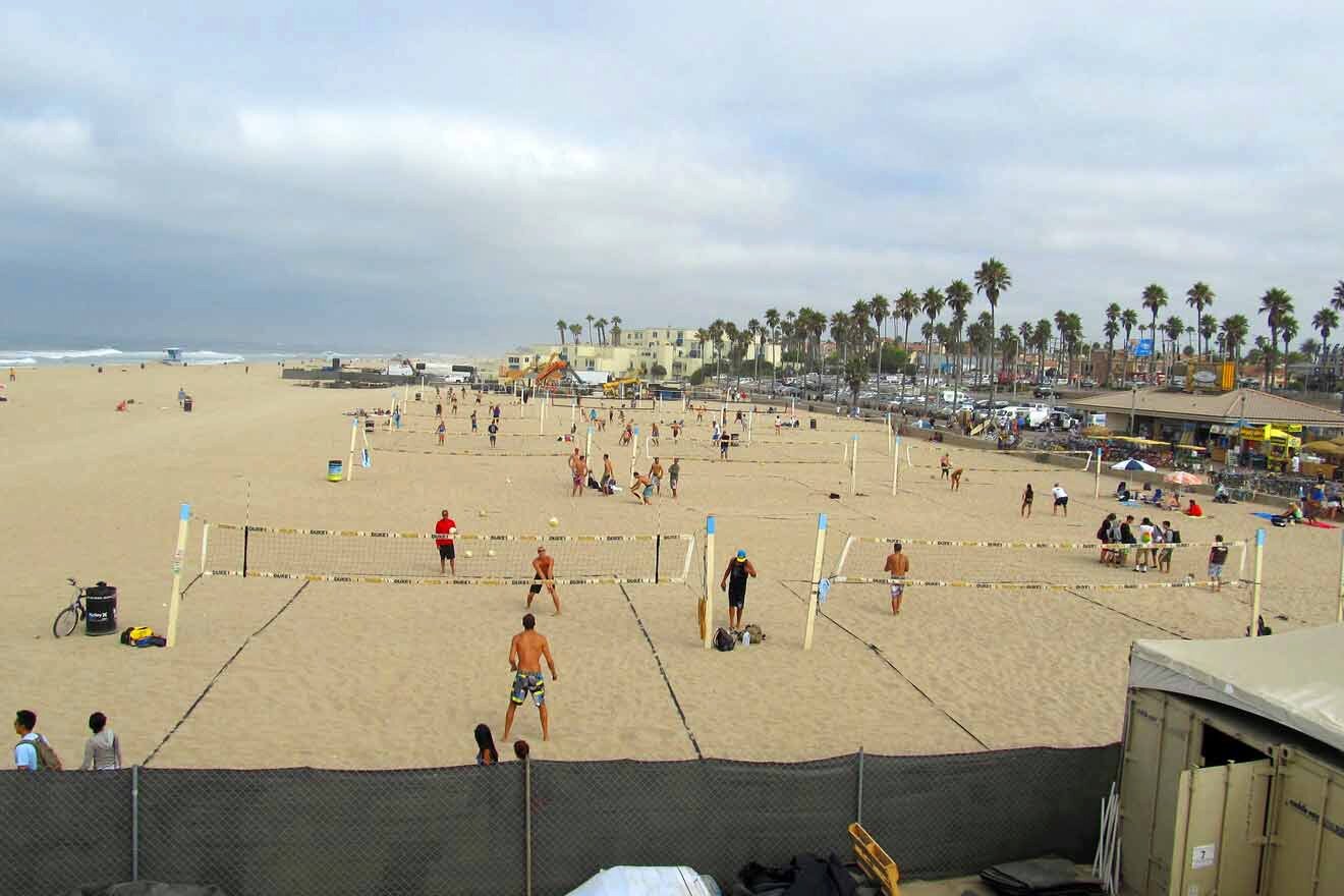 A group of people playing volleyball on a beach.