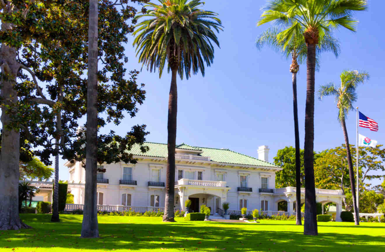 view of a mansion with palm trees in front of it