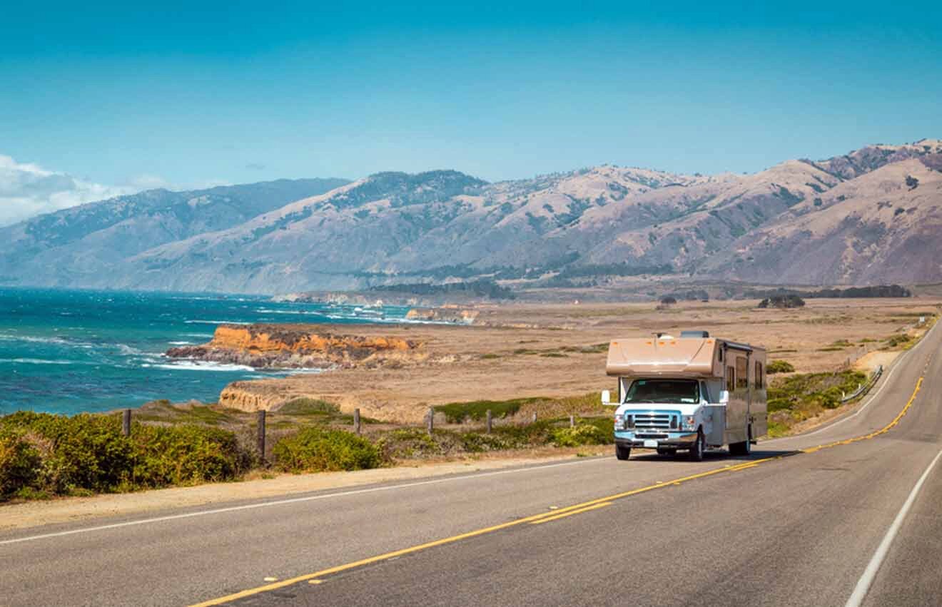 An rv truck driving down a road near the ocean.