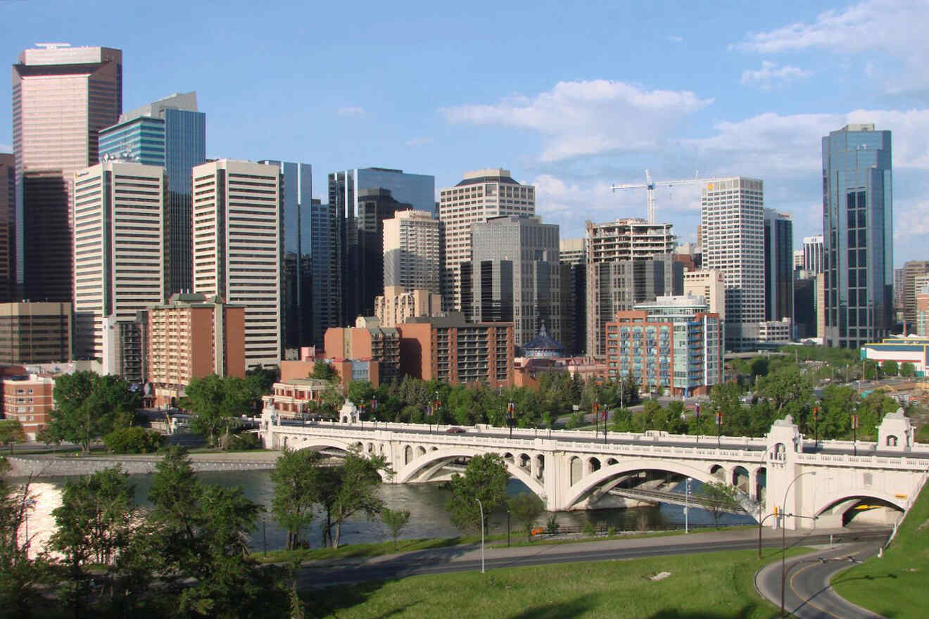 view of a city with a bridge over a river and tall buildings in the background