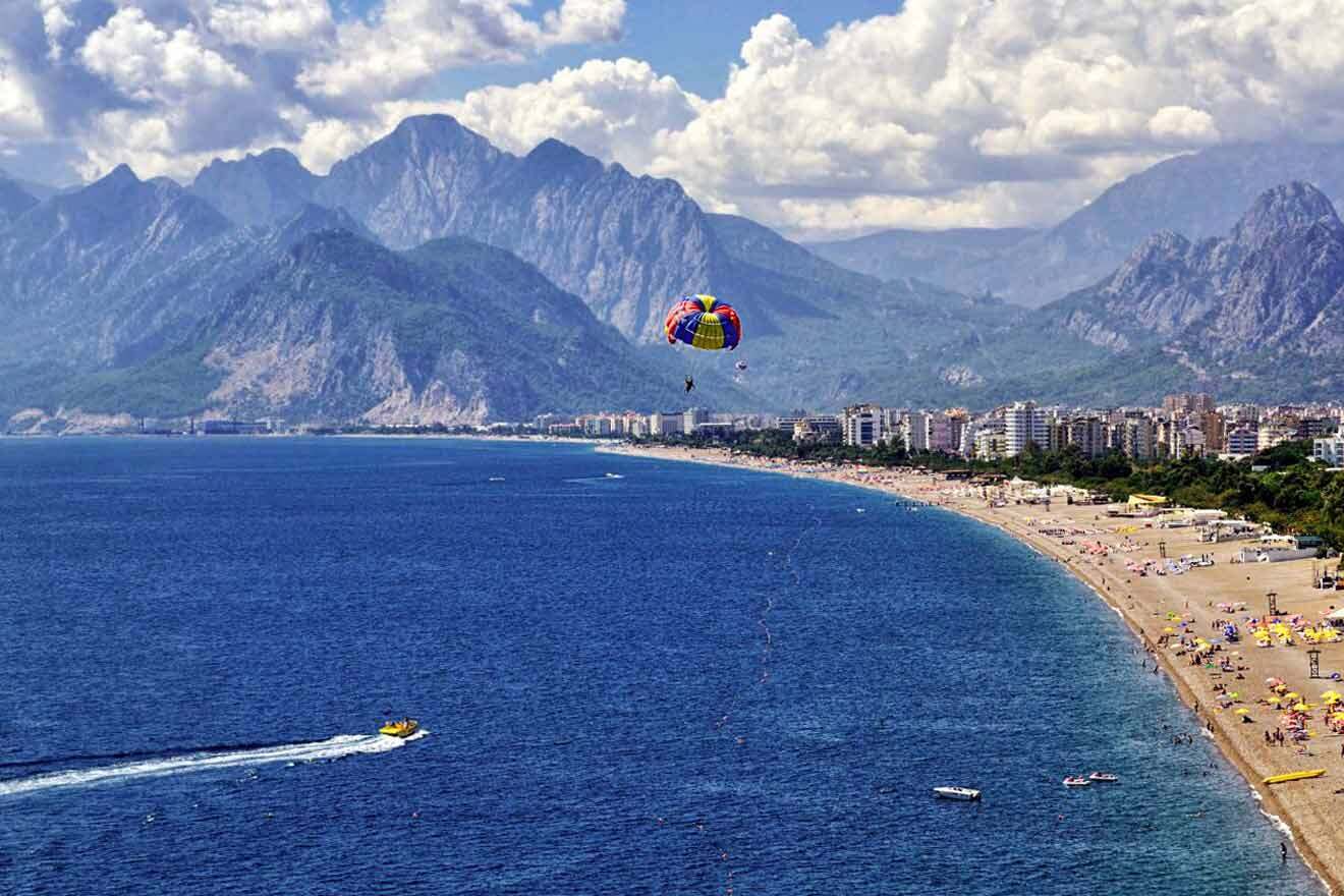 A beach with people on it and mountains in the background.