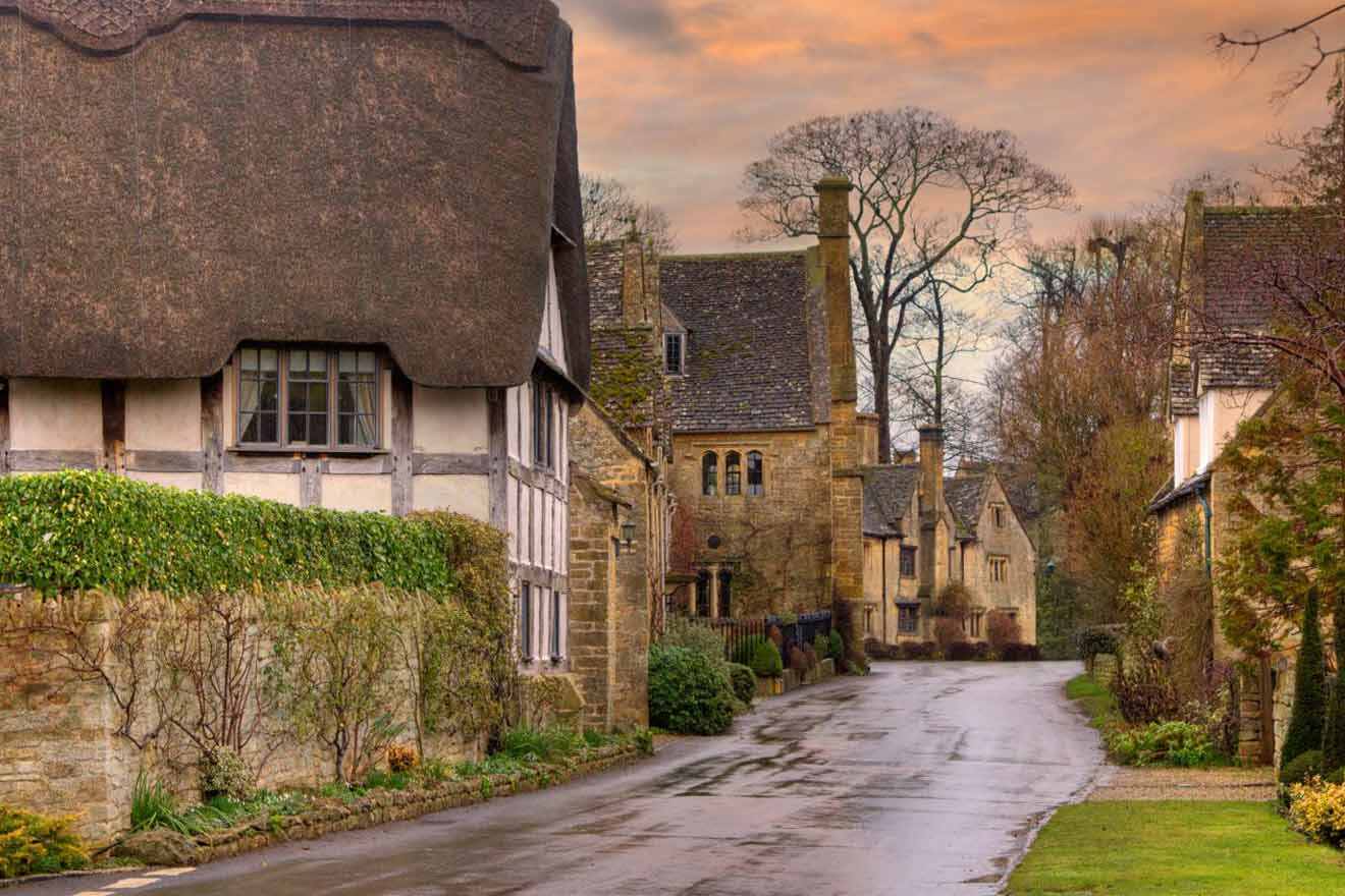 A street lined with thatched cottages in the cotswolds.