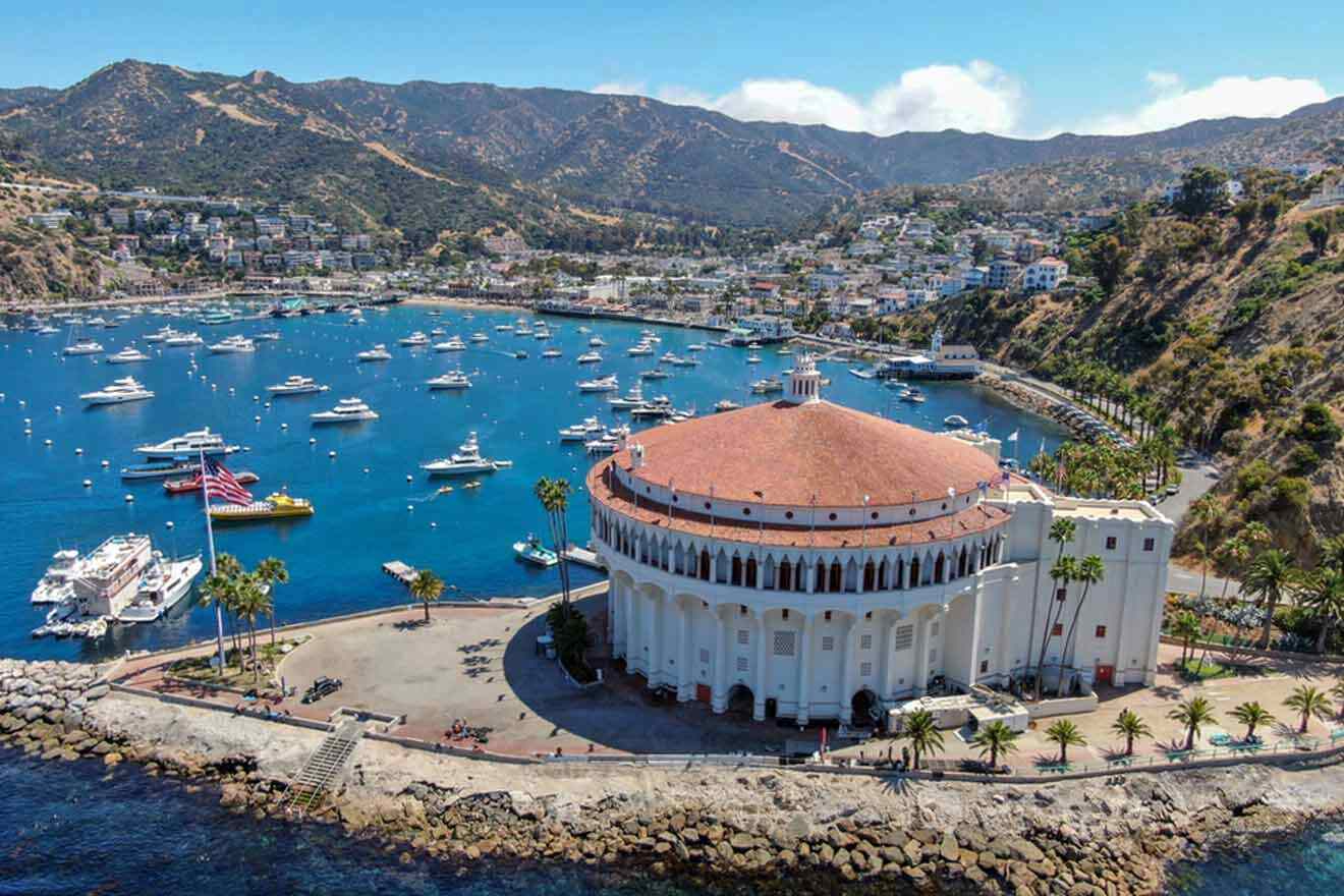 A boat docked in a harbor and a white building