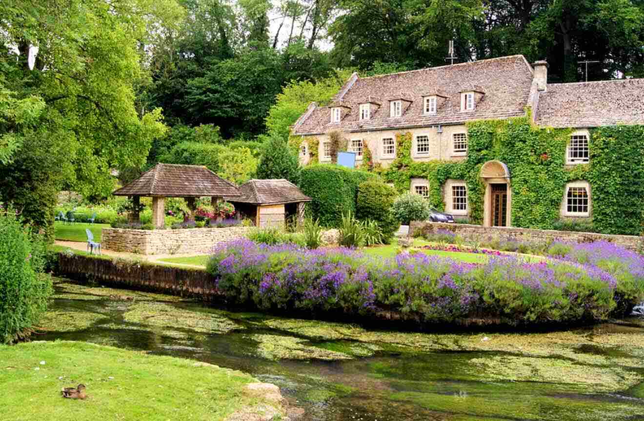 A house with a garden and a lake in front of it