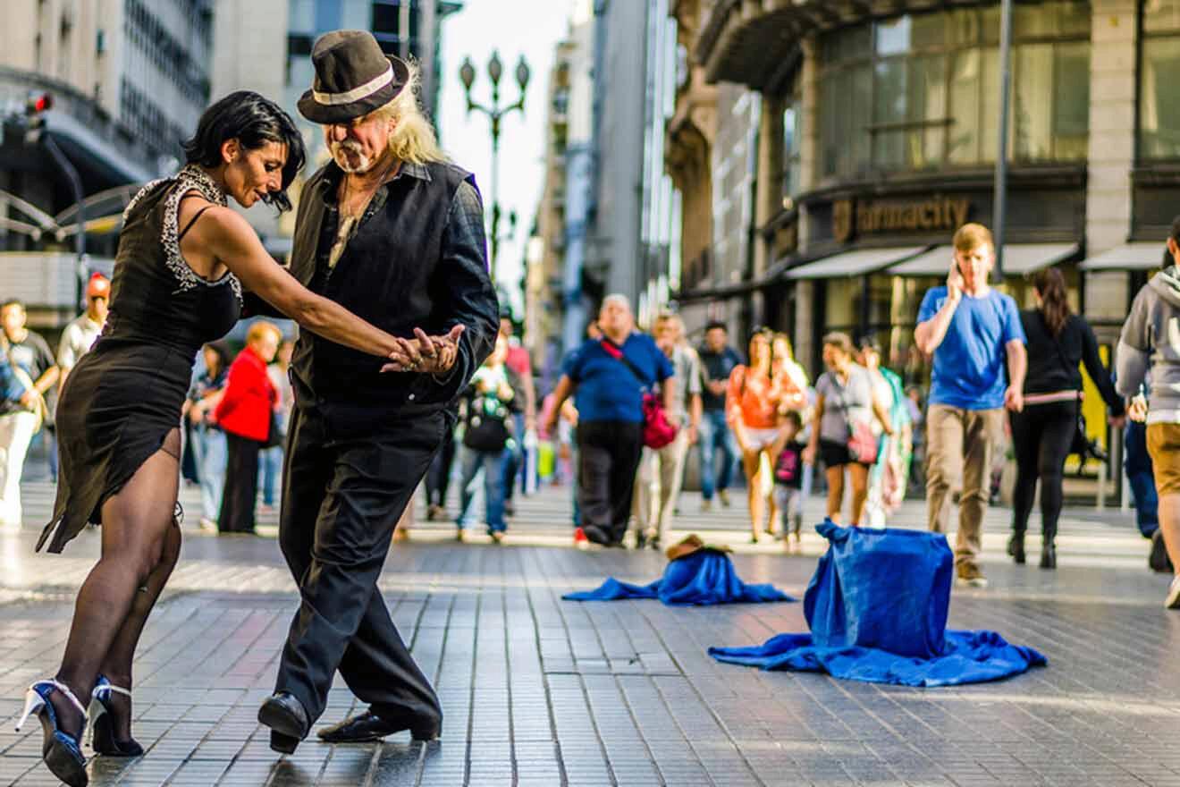 A man and woman dancing on a city street in Buenos Aires.