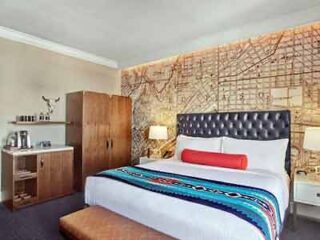 A hotel room with a map on the wall.