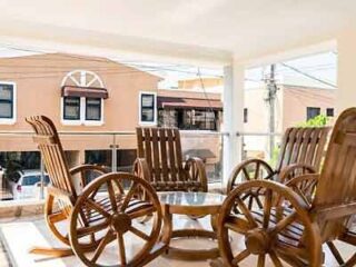 Four wooden chairs on a balcony