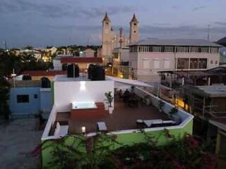 An aerial view of a hotel's rooftop at dusk.