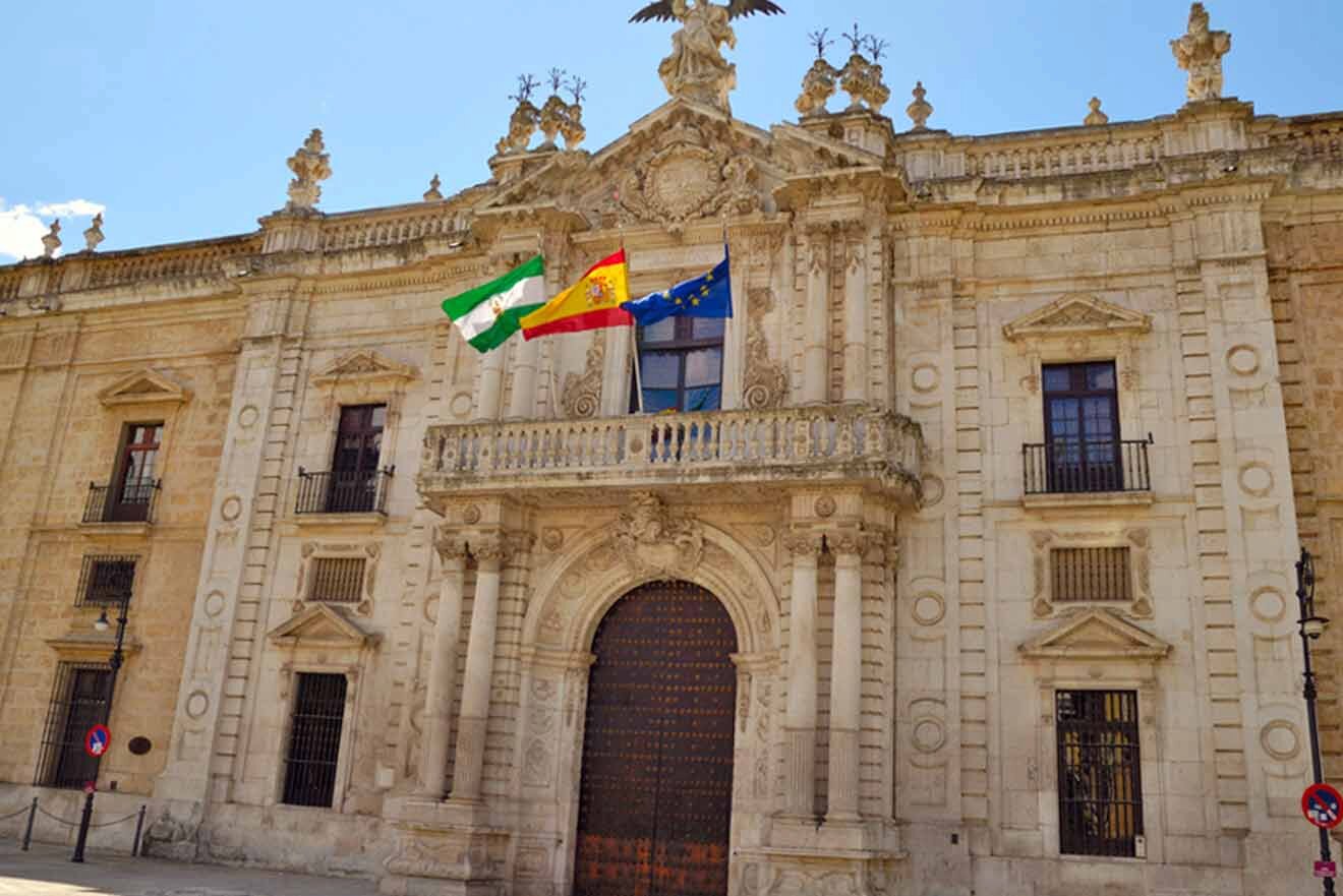 The exterior of a building with two flags on it.