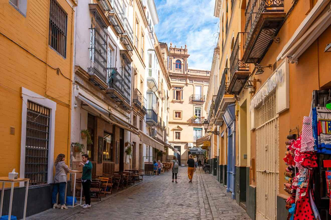 A narrow cobblestone street in a city in spain.