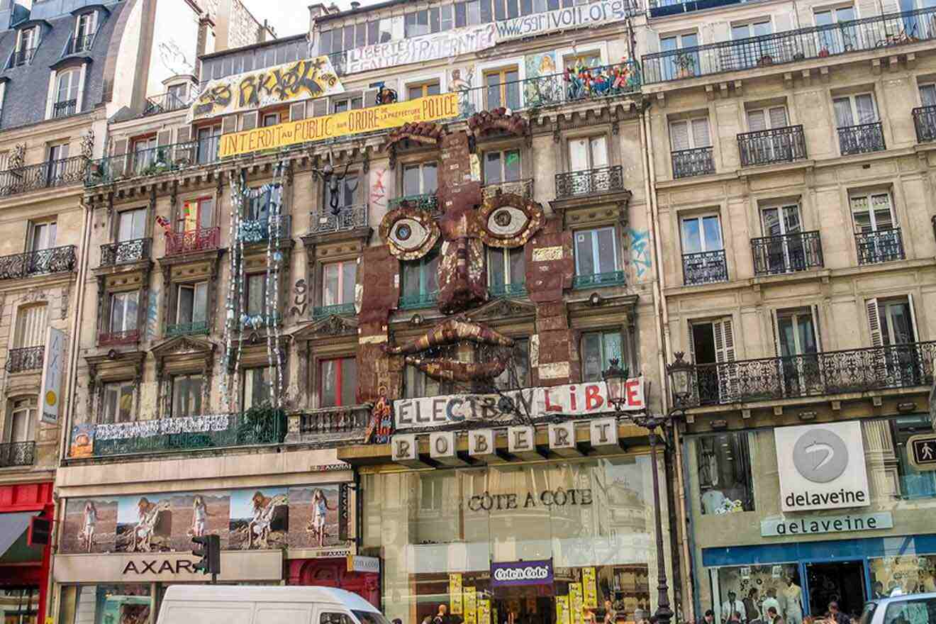 A building in paris with a large face on it.
