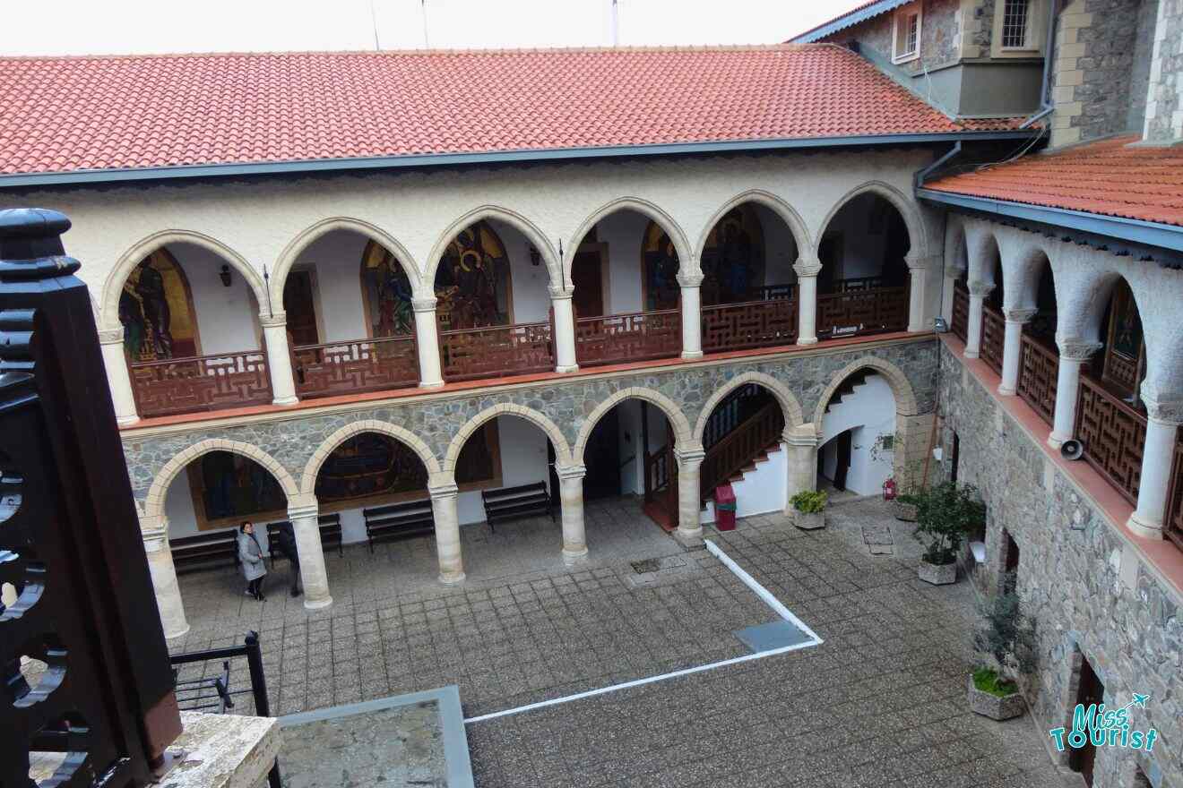 The courtyard of a stone building with arches.