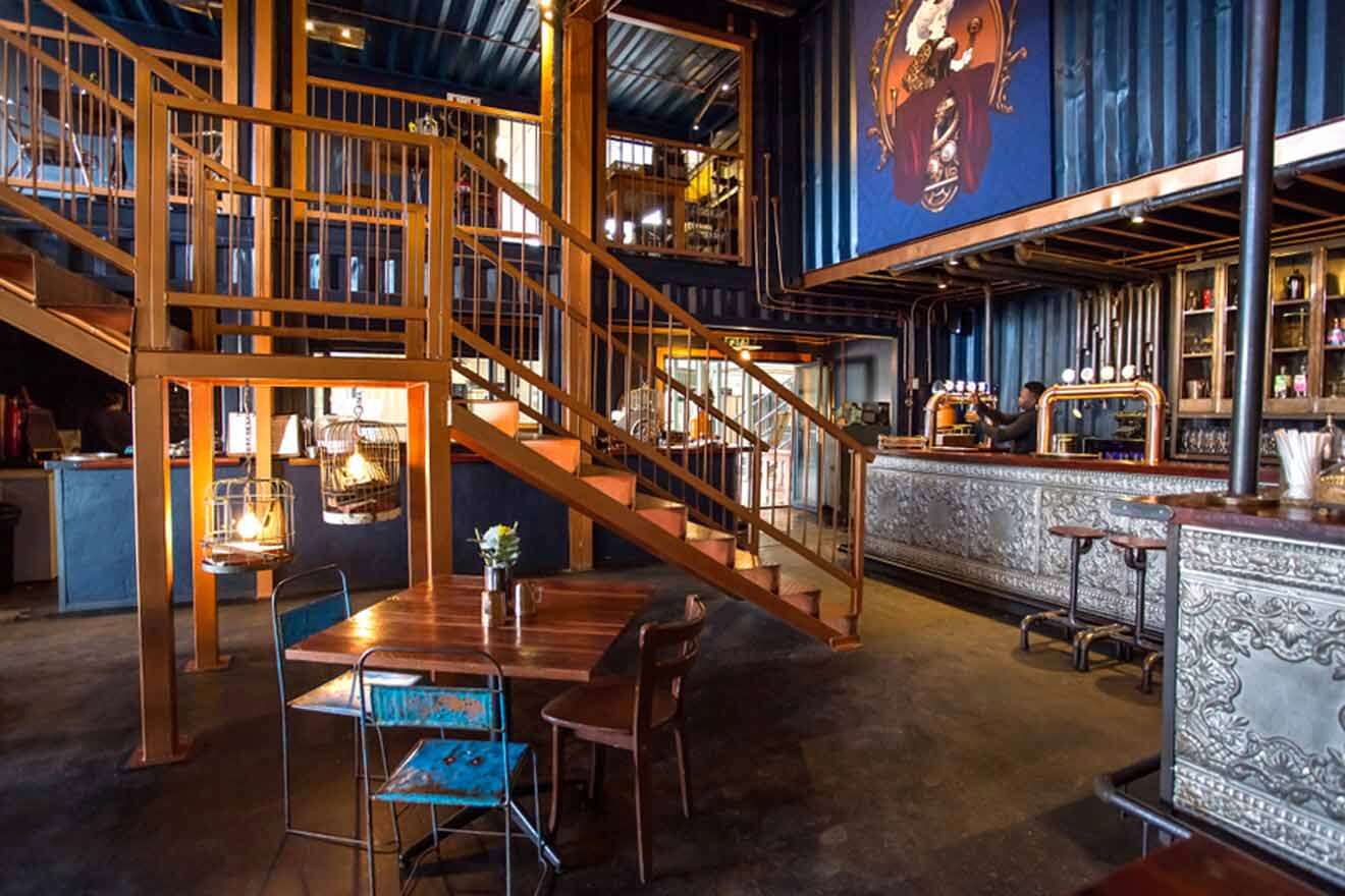 The interior of a bar with stairs and a staircase.