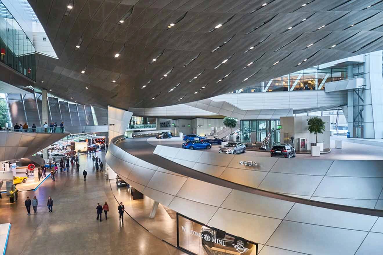 The interior of a modern building with a lot of cars in it.